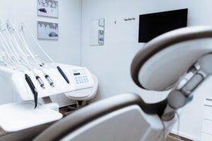 Modern dental treatment room with chair and equipment supplied by Aura Infection Control, managed via an integrated business system